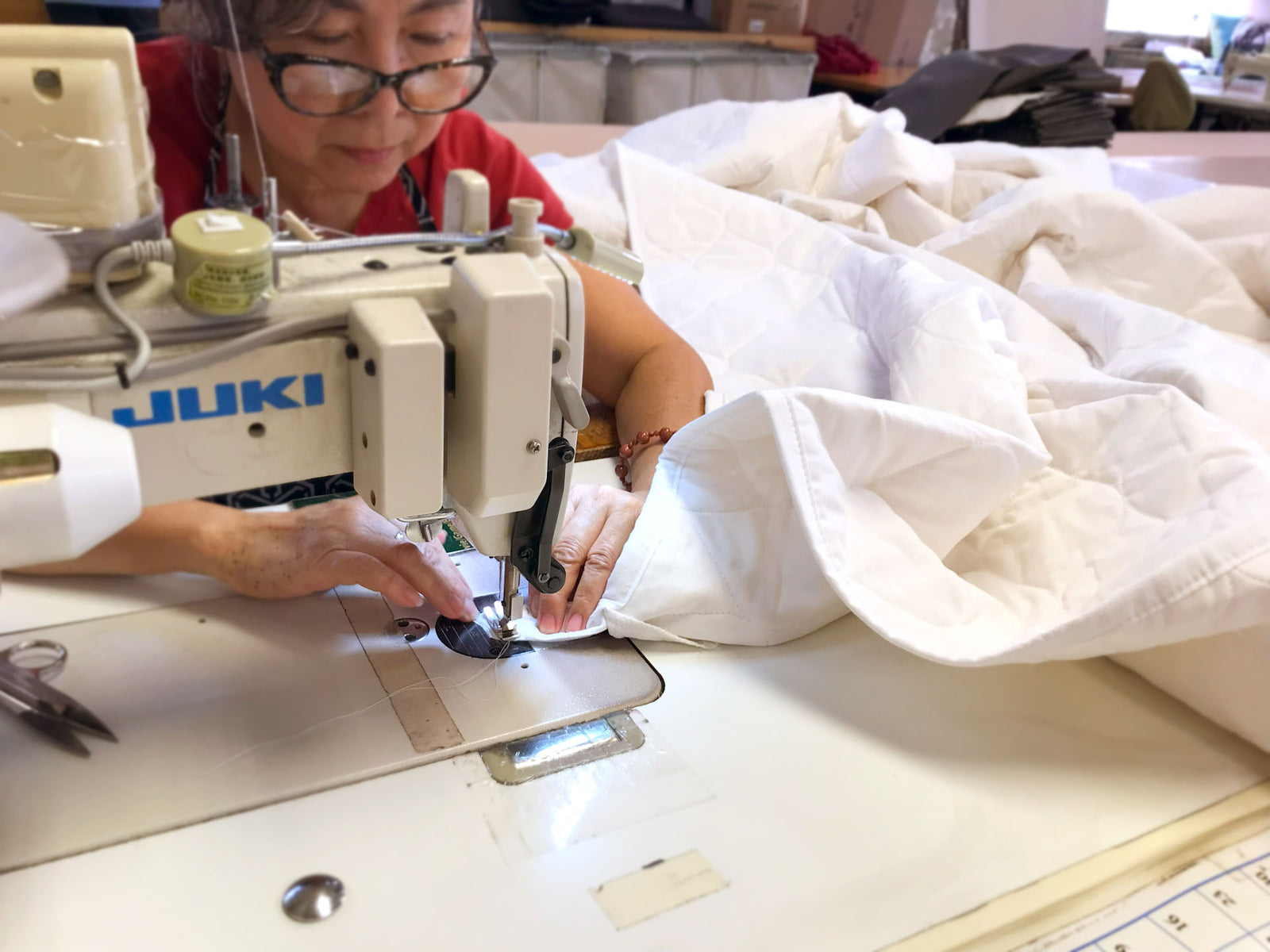 Lady sewing a quilt