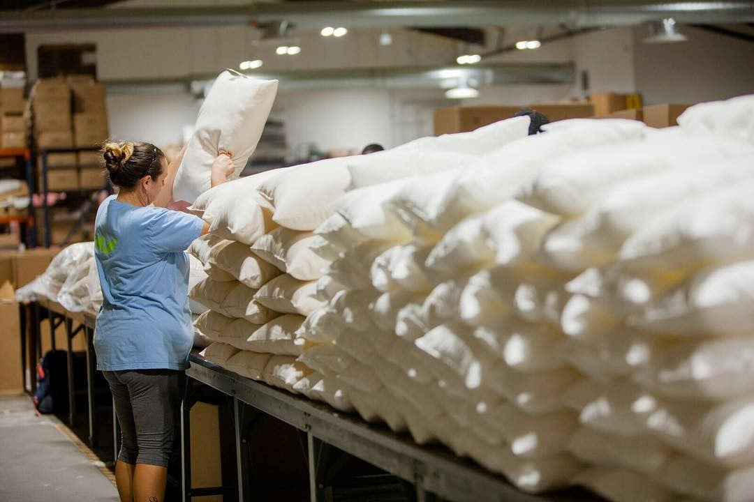 Woman Making Down Alternative Pillow With Recycled Polyester Fill