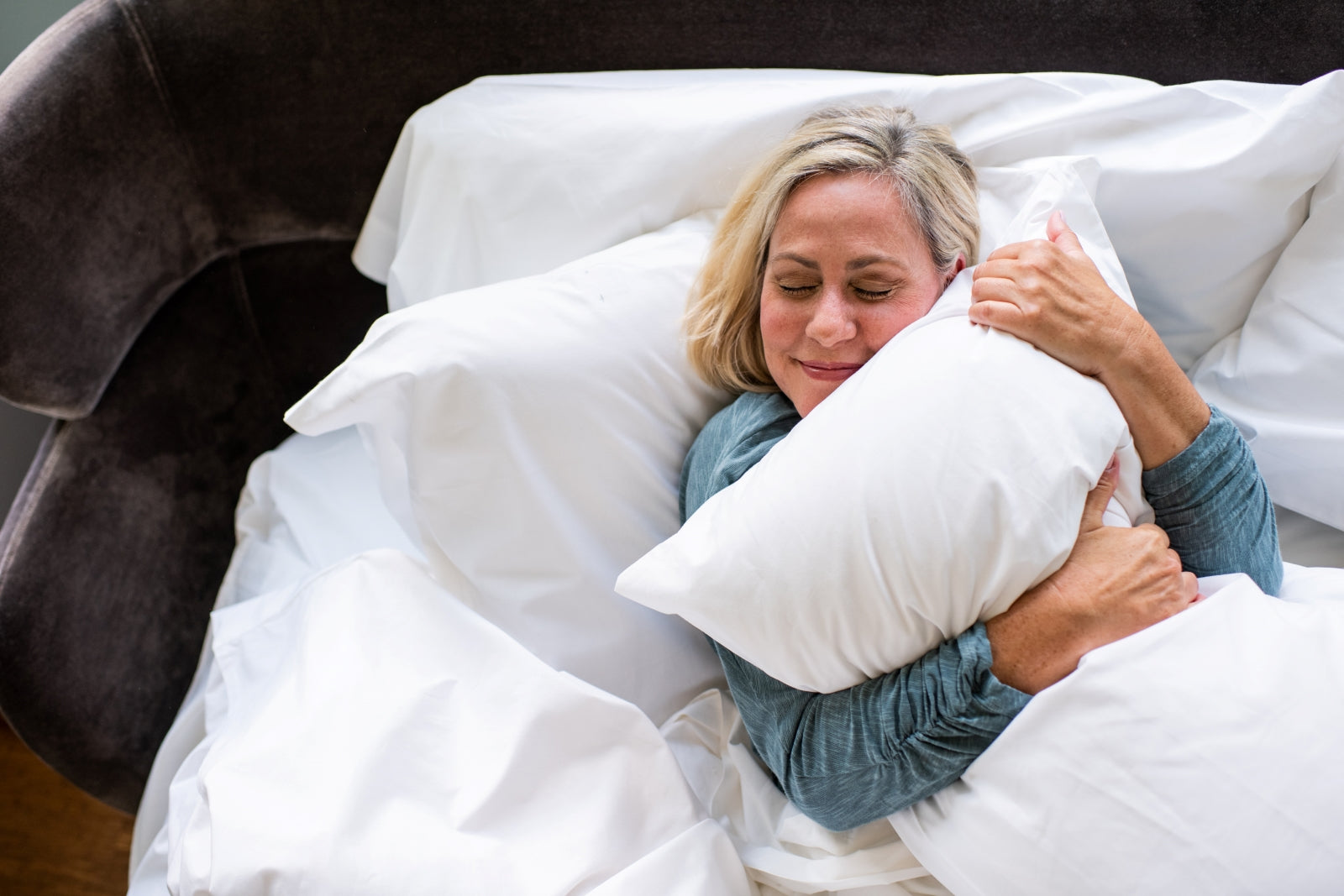 Lady hugging a pillow