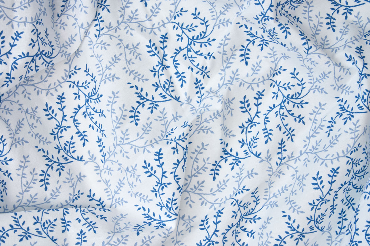 Close-up of blue floral print on cotton pillowcase fabric