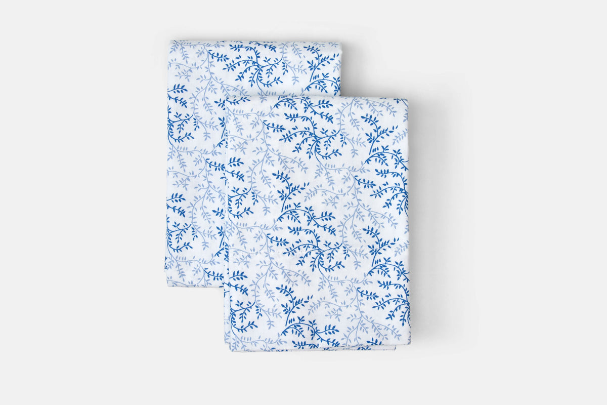 Set of white cotton pillowcases with blue floral print