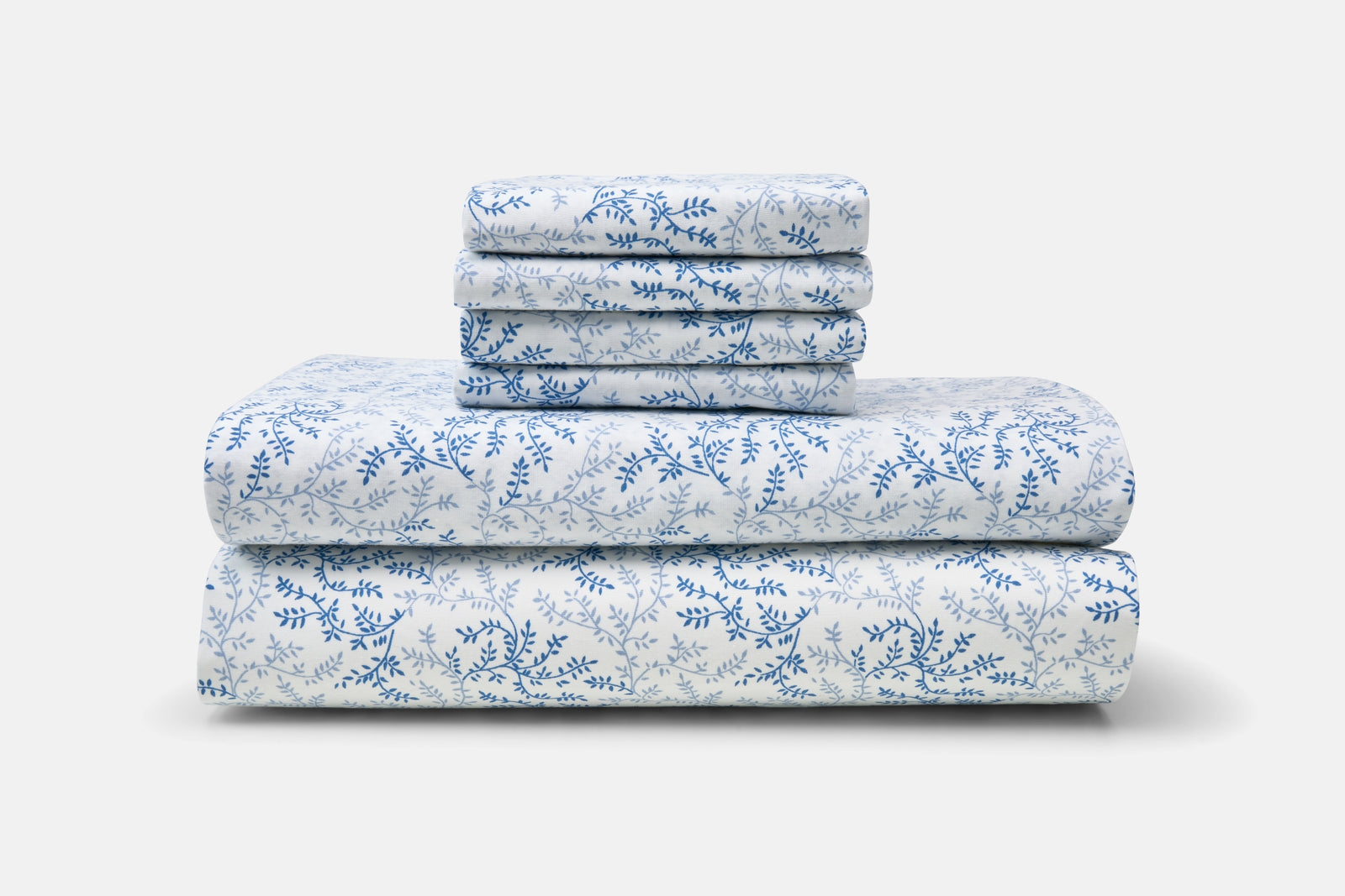 Set of cotton bed sheets with blue floral print, folded and stacked