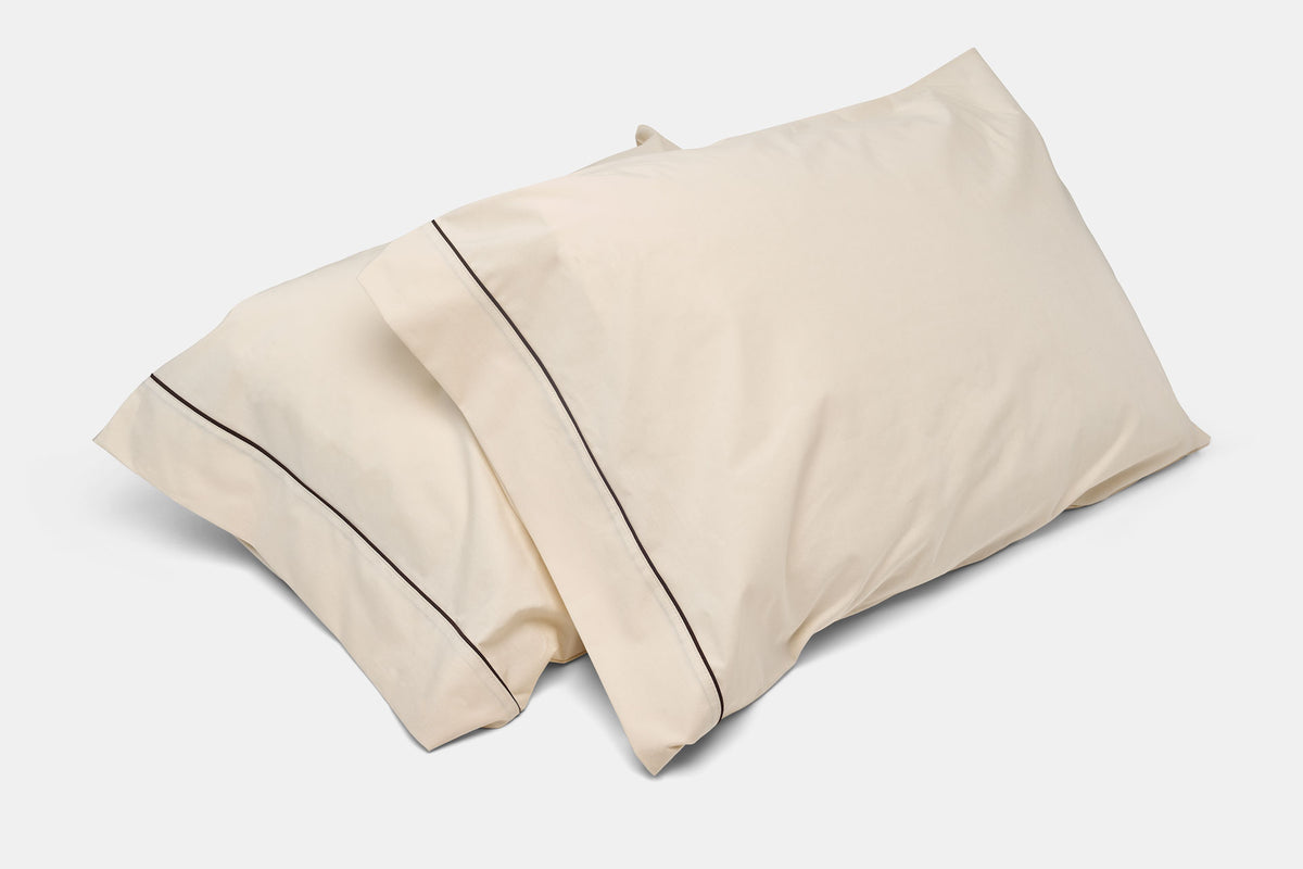 Cream-colored pillowcases with piping, cotton bedding, made in USA