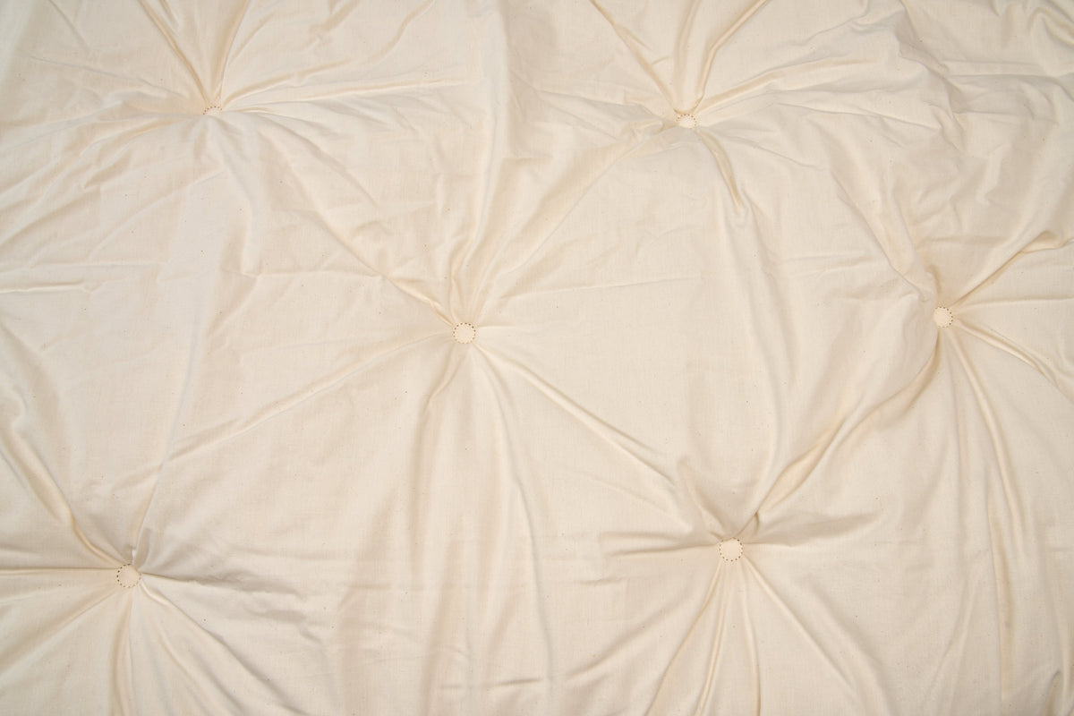 Close-up of tufted wool topper